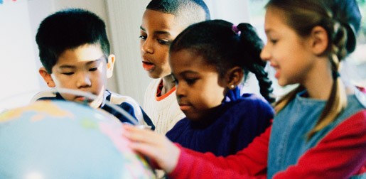 Children round a globe