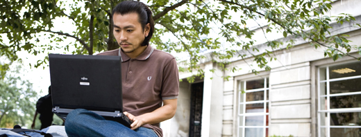 Student working outside on a laptop 