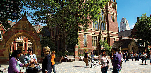 Students on campus with the Great Hall and the Parkinson Building in the background