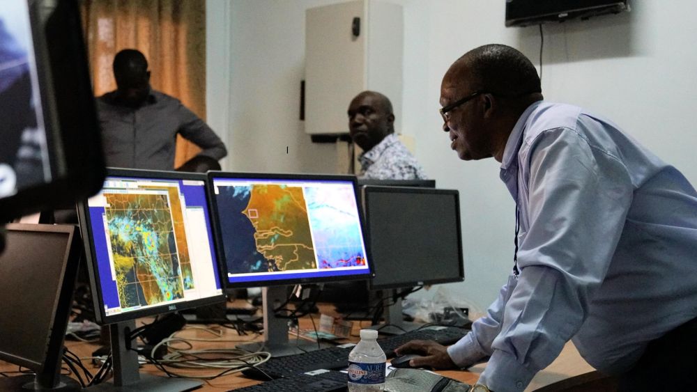 Forecasters looking at weather maps on a computer screen.