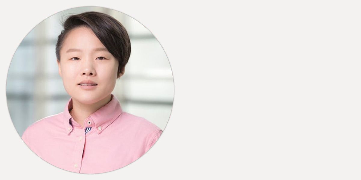 Ji Yoon smiling in front of a sunny background.