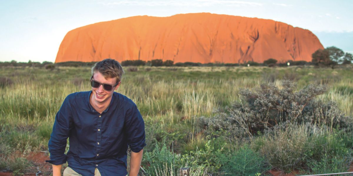 Student smiling near Uluru/Ayers Rock in Australia