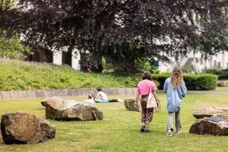 Two students walking through a park