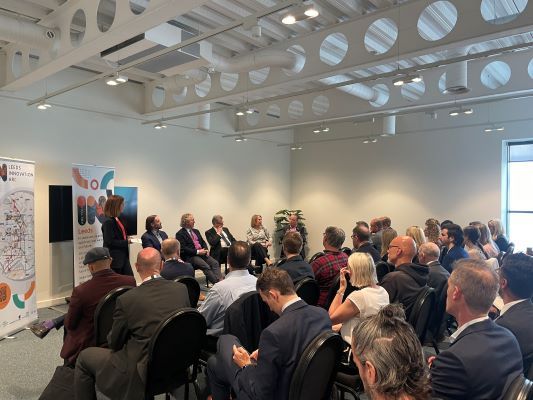 A speaker addresses the audience at an event during a property conference