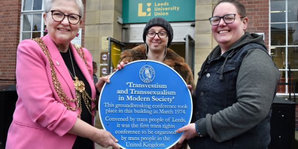 Lord Mayor, Councillor Al Garthwaite, Councillor Hannah Bithell and Gossipgrrrl hold the blue plaque outside the Leeds University Union building.