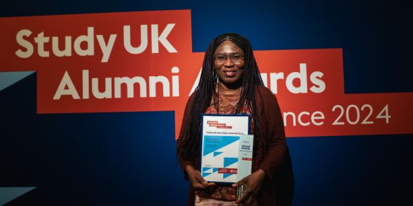 Chikaodili Mary-Kate Deng stands with her British Council award