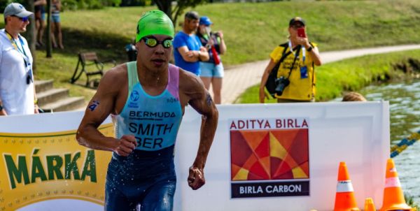 Tyler Smith runs out of the water during a triathlon race