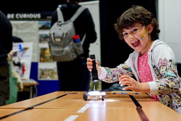 Child playing with a robotic toy.