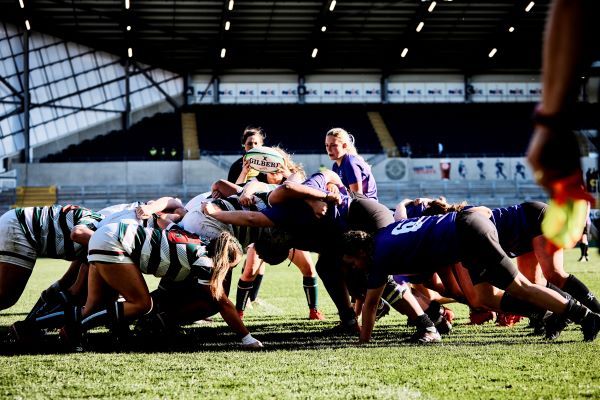 A group of rugby players on a rugby field.