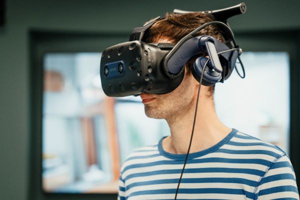 Young man wears a virtual reality headset