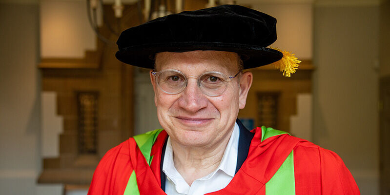 Portrait of Mark Tucker in graduation gown.