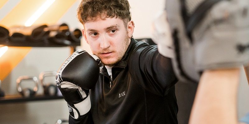 Adam in the gym wearing boxing gloves