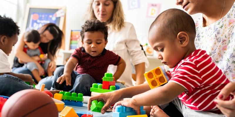 Young children playing with building blocks in a nursery