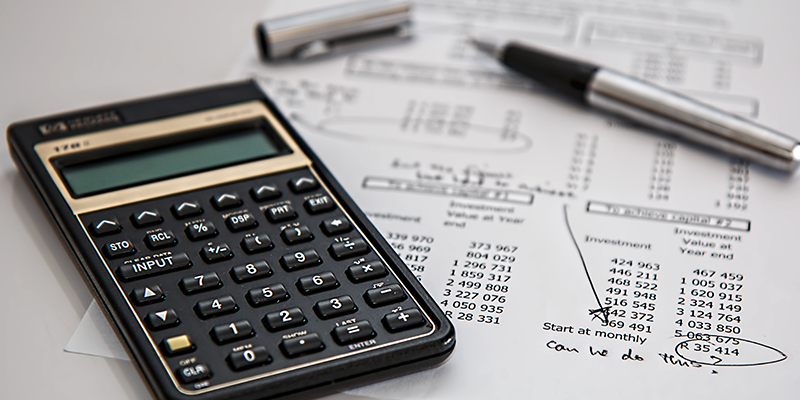 Calculator on paper with business calculations