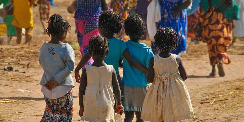 Group of school children in Dakar, Sengal with their backs to the camera.