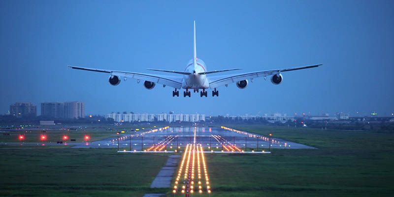 A large, heavy jetliner landing at an airport.