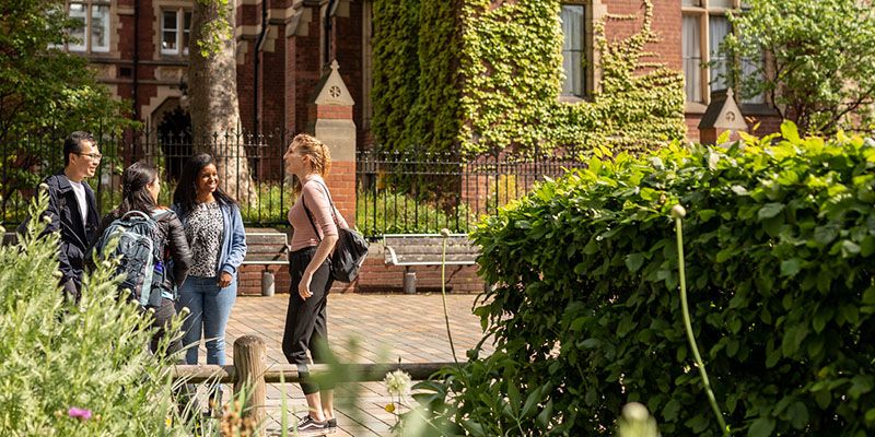 Four students in conversation on campus.