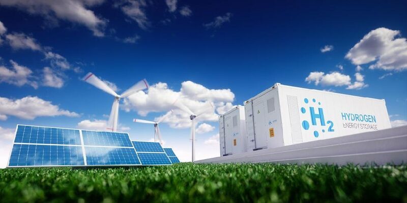 Solar panels, wind turbines and Hydrogen energy storage unit against blue sky