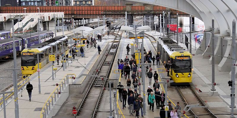 Metrolink Platforms at Manchester Victoria Station busy with commuters.