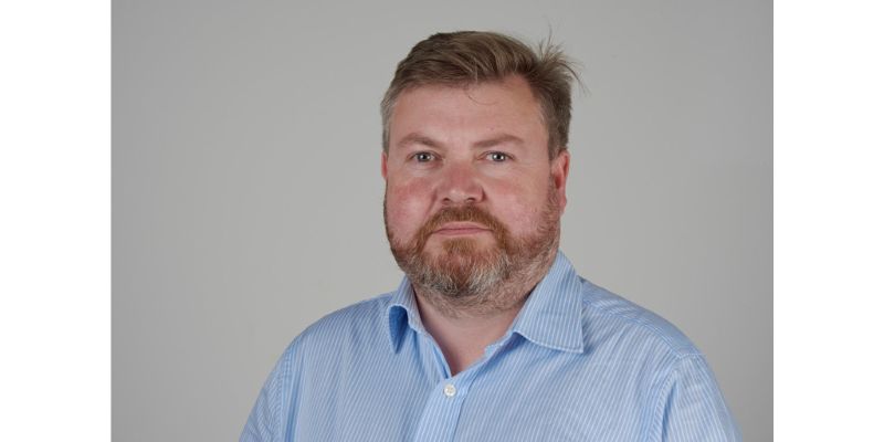 Photo of Dr Nick Cartwright. A white man with brown hair and a beard