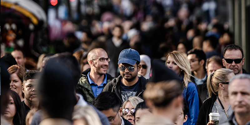 A busy city street with many people walking on the pavement