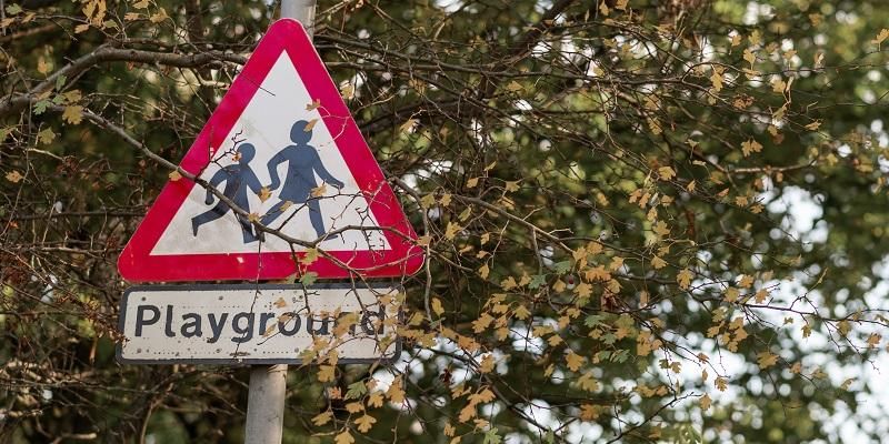 Street sign which says &#039;Playground&#039;