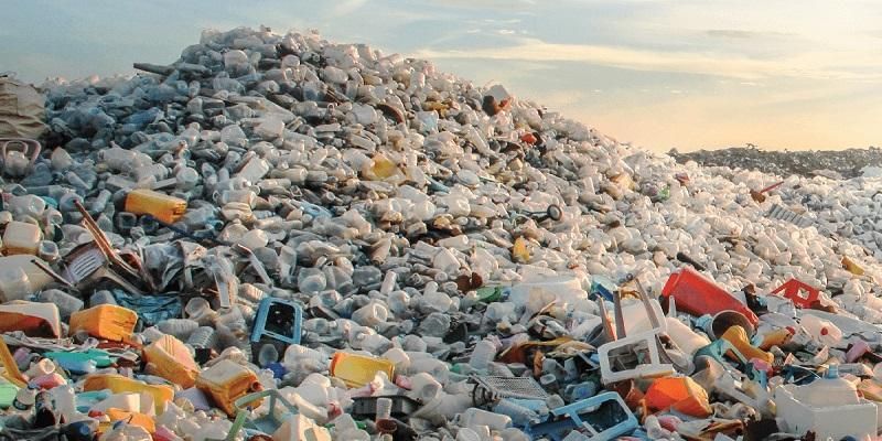 A large mountain of discarded plastic bottles and containers