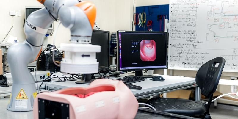 The image shows the robotic arm that hoovers above the patients to navigate the capsule inside the patient.