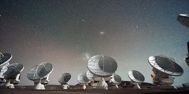 Image shows the dishes of the ALMA radio telescope which is based in the Atacama desert in Chile.