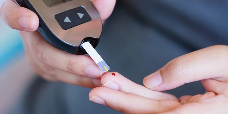 A person pricks their finger as they test the glucose levels in their blood