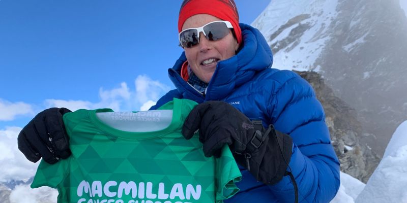 Shaunna Burke holds a Macmillan Cancer Support shirt at the summit of Lobuche East