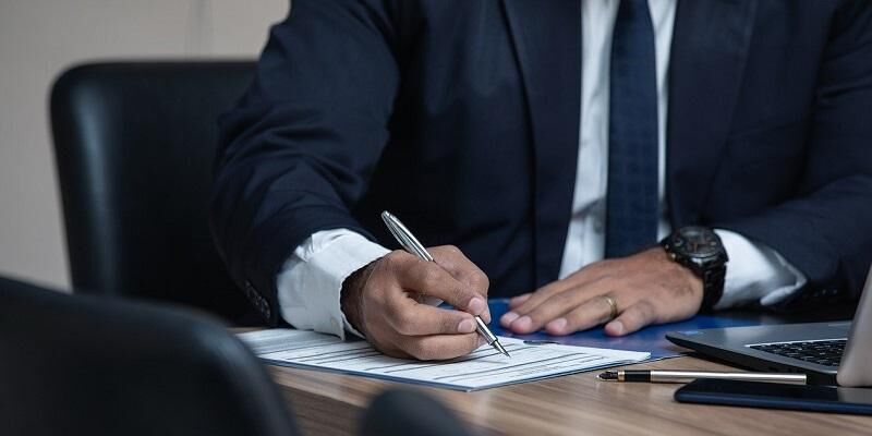 A lawyer writing at an office desk