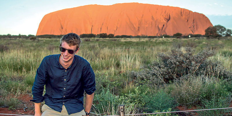 Student smiling near Uluru/Ayers Rock in Australia