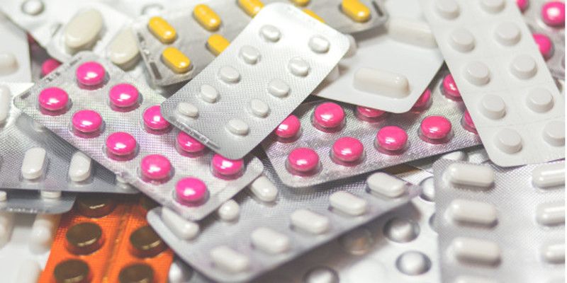 A pile of brightly coloured tablets in blister packs