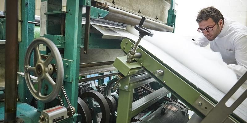 Researcher with textile machinery.