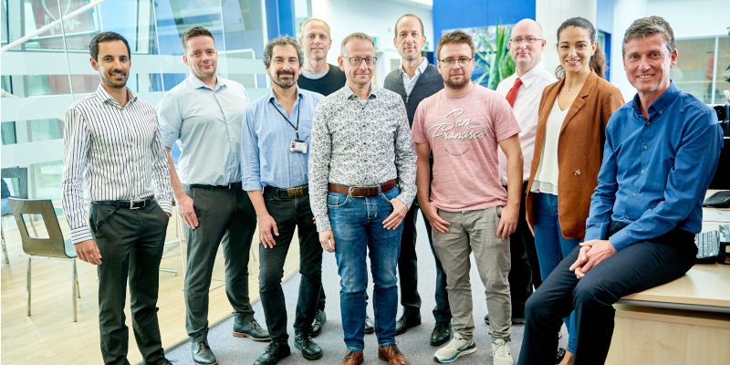 Group shot of the CalTIC team outside a science lab.