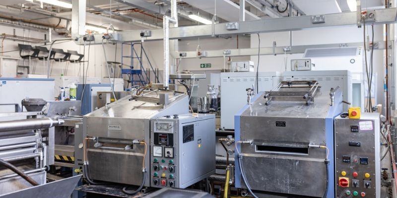 Multiple silver square machines in the Wet and dry processing lab School of Design. 