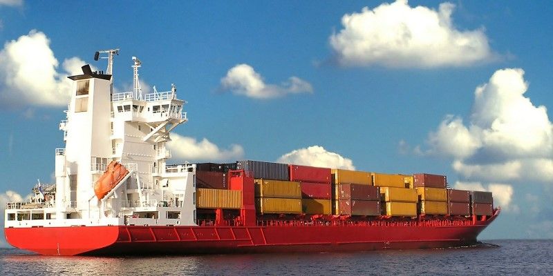 A cargo ship piled with shipping containers