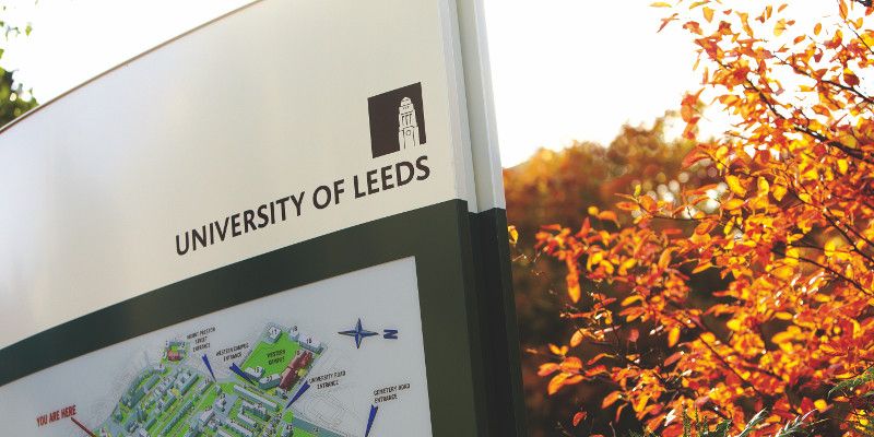 Map of campus next to an autumnal tree