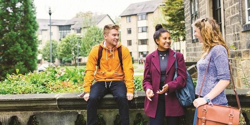 A group of students chatting outside the entrance to Oxley residence