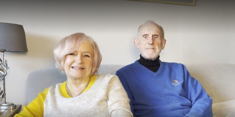 Judy Hatton and her husband Trevor Thewlis sitting on their sofa at home in Leeds