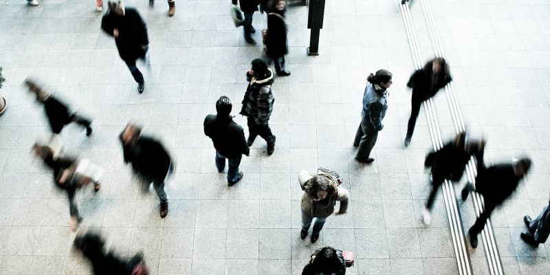 A crowd of people in a public space, seen from above