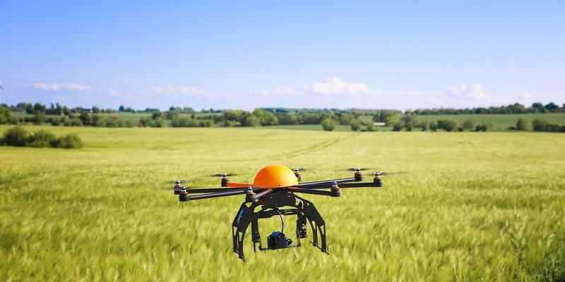 A drone on the ground in a field.