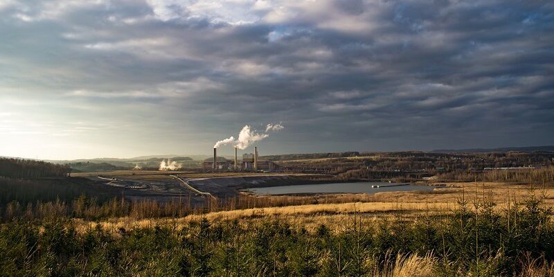 Landscape with factory in background