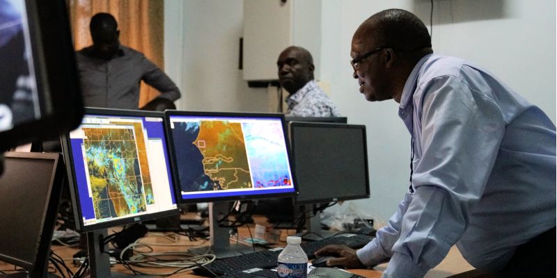 Weather scientists examining data on computer screens