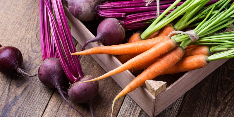 Carrots and beetroot in a wooden box.