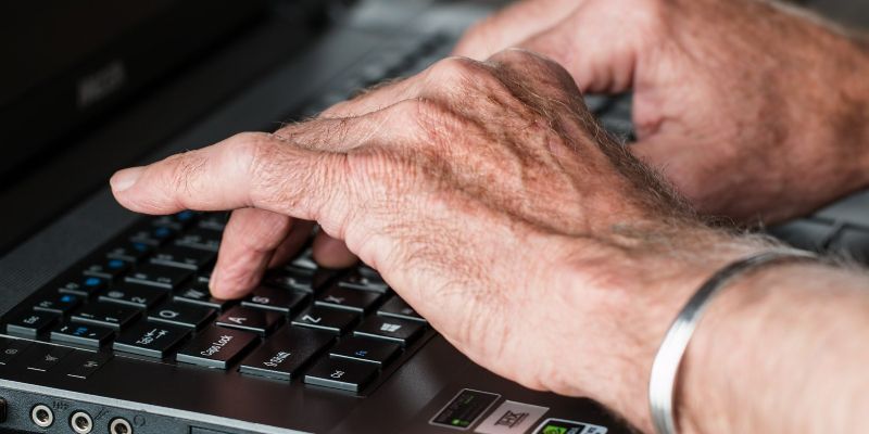 hands typing on a laptop keyboard