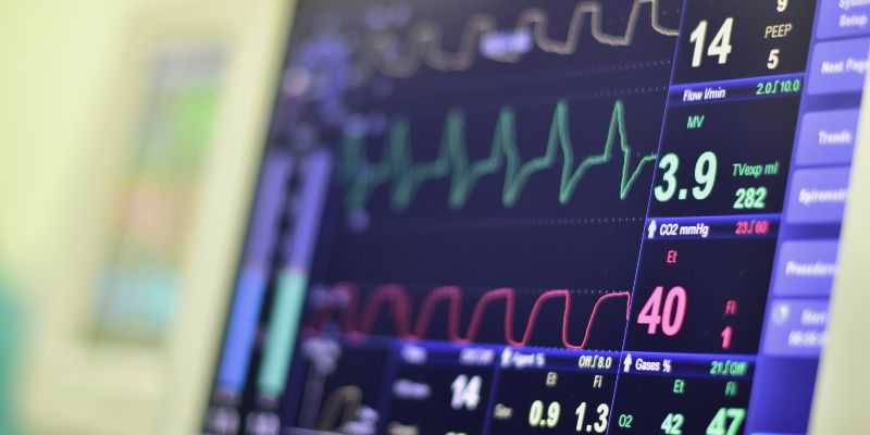 A heart rate monitor screen showing numbers and heart rate waves