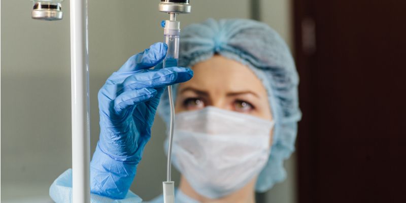 Nurse checking chemotherapy drip apparatus.