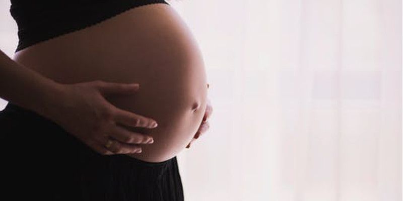 Picture shows a pregnant woman hold her 'bump'